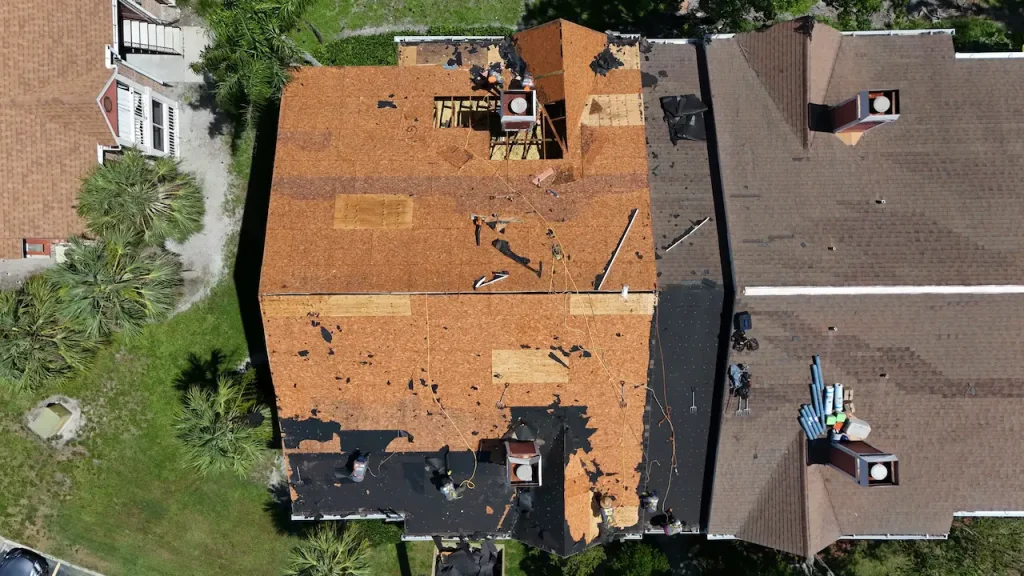 Aerial view of an HOA roofing contractor completing a roof replacement on a residential complex
