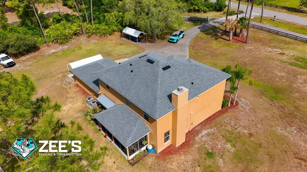 Aerial view of completed roof replacement on Orlando home with new asphalt shingles after storm damage