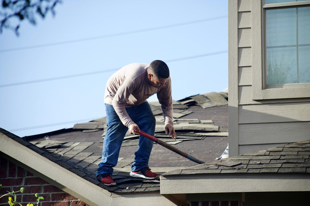 Roofing contractor inspecting shingles during roof repair vs replacement assessment on Orlando Florida home